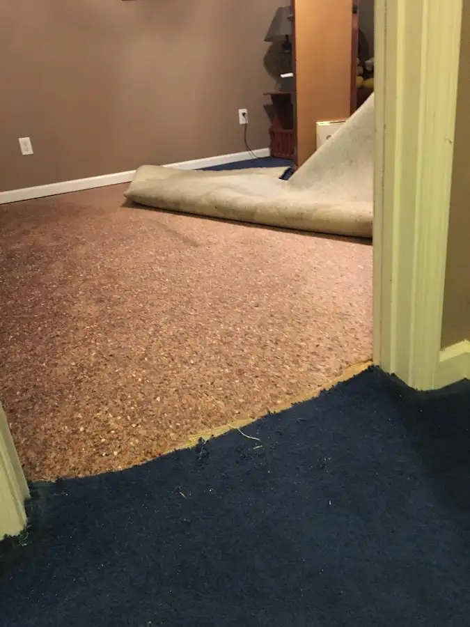 Carpet pad removal revealing water damage during Water Mitigation Services in Barstow